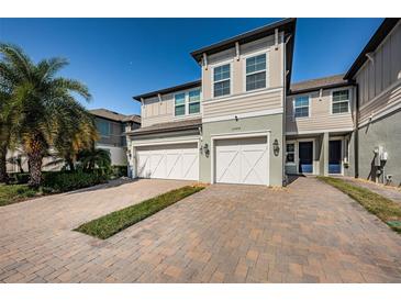 Two-story townhome with two-car garage and attractive landscaping at 2444 Foggy Creek Cir, Clearwater, FL 33764