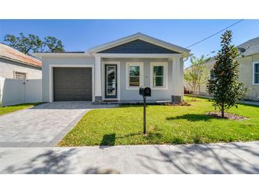 Modern house exterior with gray garage door and gray accents at 2921 Sanchez St, Tampa, FL 33605