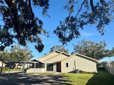 Tan house exterior with carport and landscaping at 2288 Citrus Ct, Clearwater, FL 33763