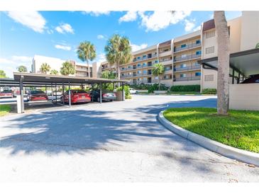 Covered parking area with additional open parking at 90 S Highland Ave # 1115, Tarpon Springs, FL 34689