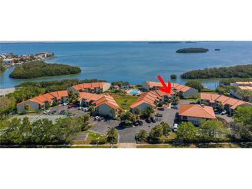 Aerial view of waterfront condos with pool and tennis courts at 1515 Pinellas Bayway S # B28, Tierra Verde, FL 33715