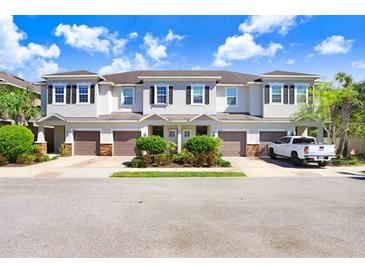 Three-unit townhouse building with attached garages at 1408 Syrah Dr, Oldsmar, FL 34677