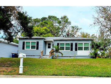 Charming one-story home with gray siding and black shutters at 1554 Elmwood St, Clearwater, FL 33755