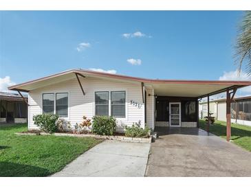 Single story home with covered carport and landscaping at 3121 Briar St, Wesley Chapel, FL 33543