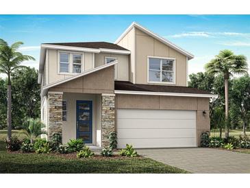 Two-story home with stone accents, two-car garage, and landscaping at 31046 Pendleton Landing Cir, Wesley Chapel, FL 33545