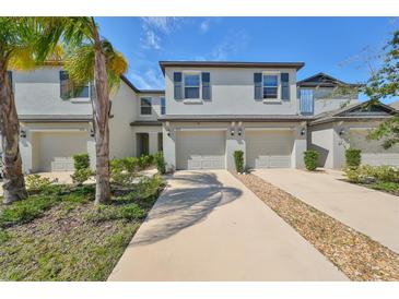 Three-unit townhome building with attached garages at 928 Royal Empress Dr, Ruskin, FL 33570