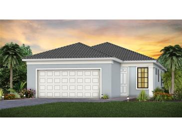 Single-story home with two-car garage and a welcoming facade at 18906 Indian Rock Pl, Lakewood Ranch, FL 34211