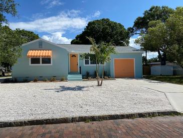 Newly renovated light teal home with orange garage door at 2658 48Th S St, Gulfport, FL 33711