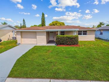 Single story home with a well-manicured lawn at 3525 Umber Rd, Holiday, FL 34691