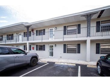 Exterior view of a light-grey building with parking in front at 101 Lake Ne Ave # 211, Largo, FL 33771