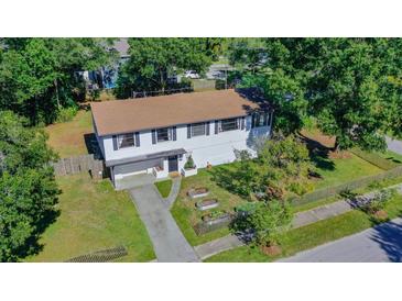 White two-story house with a garden and driveway, seen from above at 1003 W River Heights Ave, Tampa, FL 33603