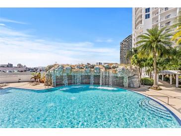 Resort-style pool with waterfall feature and palm trees at 1209 E Cumberland Ave # 508, Tampa, FL 33602