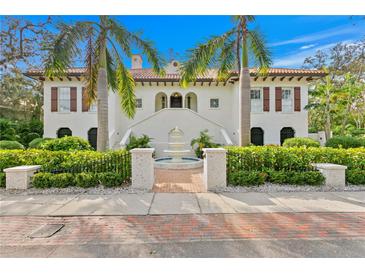 Stunning two-story home with brick walkway and fountain at 2520 W Shell Point Rd, Tampa, FL 33611