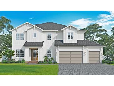 Two-story home with white siding, gray garage doors and landscaping at 3814 W Tacon St, Tampa, FL 33629
