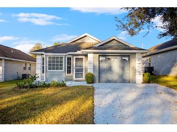 Single-story house with attached garage and landscaping at 6703 Pistachio St, Zephyrhills, FL 33542