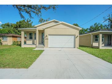 Newly constructed home with a one-car garage at 2010 E Wood St, Tampa, FL 33604