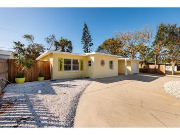 Charming yellow house with a landscaped yard and driveway at 6614 10Th Avenue S Ter, St Petersburg, FL 33707