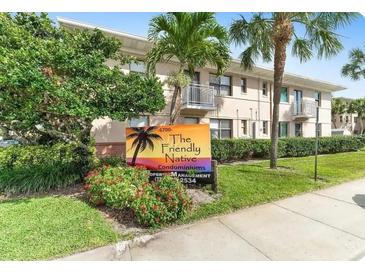 The Friendly Native Condominiums, featuring a well-maintained building and landscaping at 6700 Sunset Way # 403, St Pete Beach, FL 33706