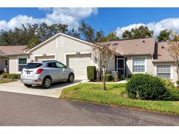 Two-car garage and well-maintained landscaping at 4234 Chesterfield Cir, Palm Harbor, FL 34683