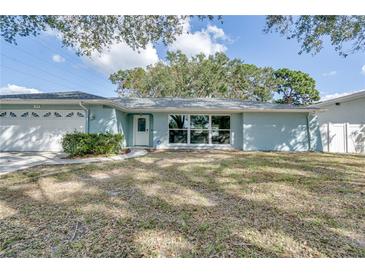 Light blue single story home with a two car garage at 3275 Fox Hill Dr, Clearwater, FL 33761