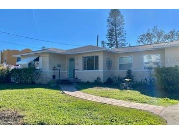 Cute ranch home with a well-manicured lawn and walkway at 1954 Bayou Grande Ne Blvd, St Petersburg, FL 33703