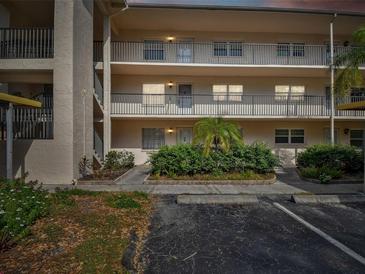 Two-story building exterior with walkway and parking at 820 Virginia St # 202, Dunedin, FL 34698