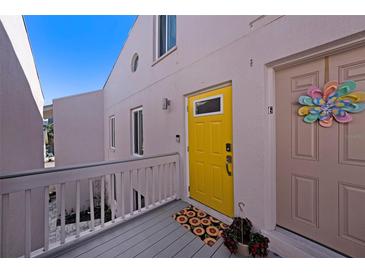 Exterior view showing a yellow front door and deck at 3120 Beach S Blvd # 7, Gulfport, FL 33707