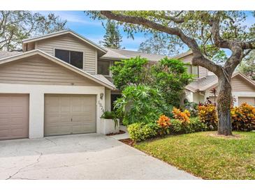 Two story home with attached garage and landscaped yard at 1924 Whispering Way, Tarpon Springs, FL 34689