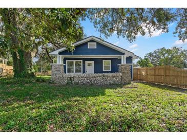 Newly renovated blue house with stone accents and a fenced yard at 1021 E 25Th Ave, Tampa, FL 33605