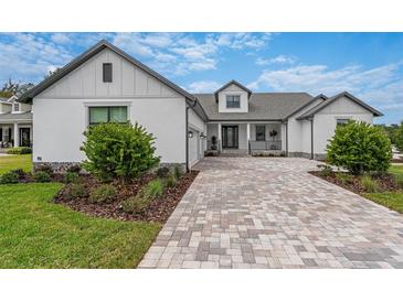 Craftsman style home with a paver driveway and landscaped front yard at 4187 Southern Valley Loop, Brooksville, FL 34601