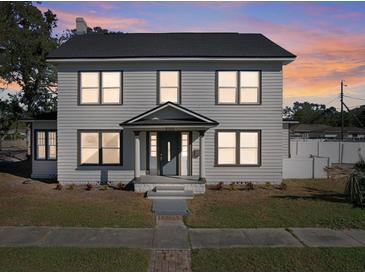 Two-story house with gray siding, dark trim, and a well-lit entrance at 500 53Rd S St, St Petersburg, FL 33707