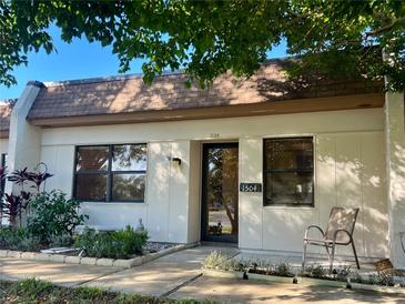 Front view of charming condo with landscaping at 1504 Mission Hills Blvd # 19C, Clearwater, FL 33759