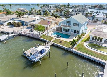 Waterfront property with a pool, dock, and boat lift at 17074 Dolphin Dr, North Redington Beach, FL 33708