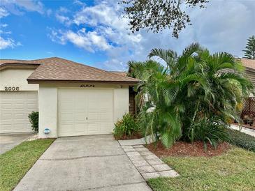 Two-car garage and nicely landscaped front yard at 2004 Westley Ct, Safety Harbor, FL 34695