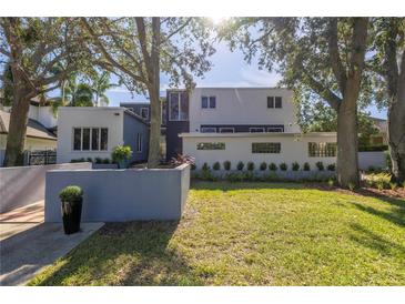 Modern home exterior with a landscaped yard and large trees at 838 Monterey Ne Blvd, St Petersburg, FL 33704
