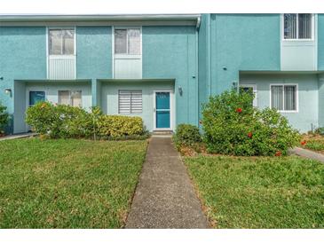 Teal condo building with walkway at 131 114Th Ne Ter # 131, St Petersburg, FL 33716