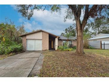 Brick ranch home with a spacious yard and a two-car garage at 609 Missionwoode Dr, Seffner, FL 33584