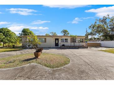 Ranch-style home with a circular driveway at 7695 17Th N Way, St Petersburg, FL 33702