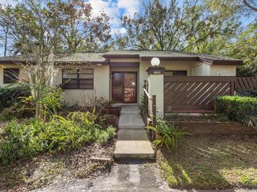 Inviting condo exterior with landscaped walkway and fenced patio at 4045 Arrowwood Ct, Palm Harbor, FL 34684