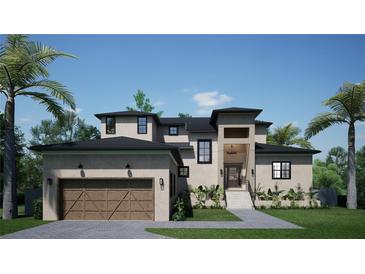 Two-story home with a modern design, attached garage, and landscaping at 2911 W Coachman Ave, Tampa, FL 33611