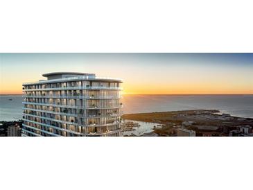 Highrise building exterior at sunset, showcasing balconies and ocean views at 400 Central Ave # 1201, St Petersburg, FL 33701