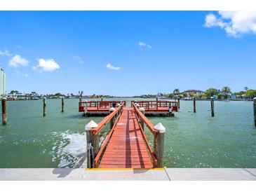 Scenic view of the community dock with seating and calm waters on a sunny day at 6363 Gulf Winds Dr # 437, St Pete Beach, FL 33706