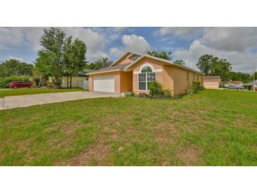 Charming single-story home with a manicured lawn, attached garage, and neutral paint at 311 Sugar Creek Dr, Plant City, FL 33563