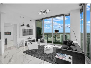 Modern living room featuring floor-to-ceiling windows and contemporary furnishings showcasing city views at 777 N Ashley Dr # 2613, Tampa, FL 33602