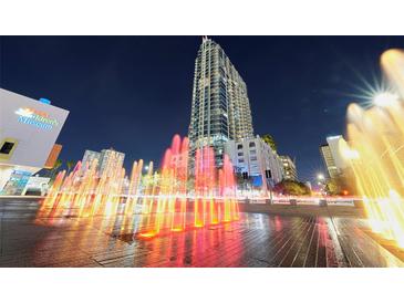 Stunning night view of a high-rise building with illuminated fountains in the foreground, creating a vibrant urban scene at 777 N Ashley Dr # 2613, Tampa, FL 33602