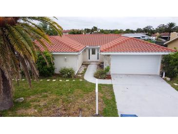 Single-Gathering home with tile roof and two-car garage at 9830 San Sierra Way, Port Richey, FL 34668