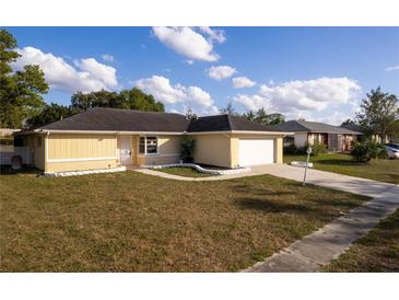 Single-story house with attached garage and well-maintained lawn at 5344 Lowell Ave, Spring Hill, FL 34609