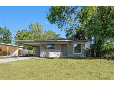 Charming ranch-style home with a well-maintained lawn at 3305 W Kathleen St, Tampa, FL 33607