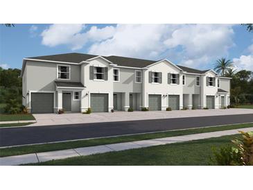 Exterior view of a row of townhouses with gray siding and green garage doors at 1566 Hammer Pl, Largo, FL 33774