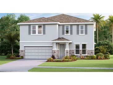 Two-story home with gray exterior, stone accents, and landscaping at 10437 Farm Hill Ave, Land O Lakes, FL 34638